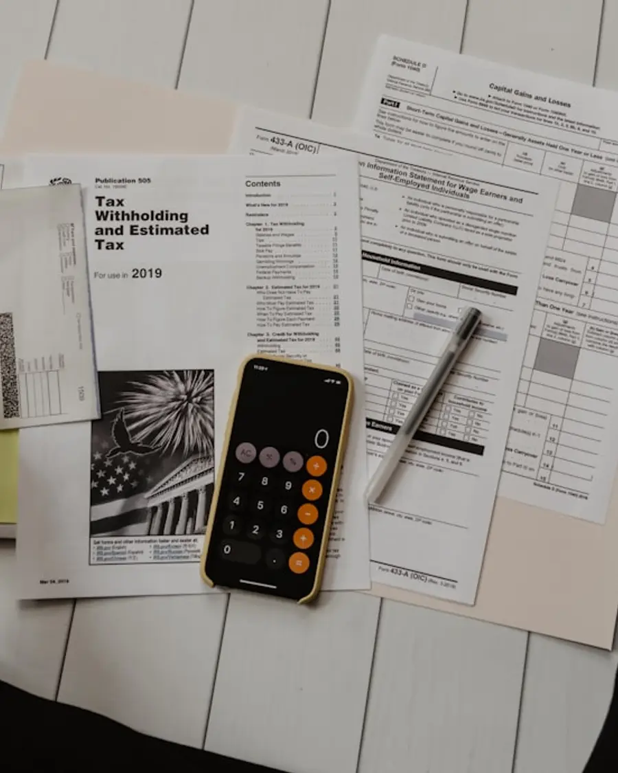 Calculator, financial statements and a pen on an accountant's desk