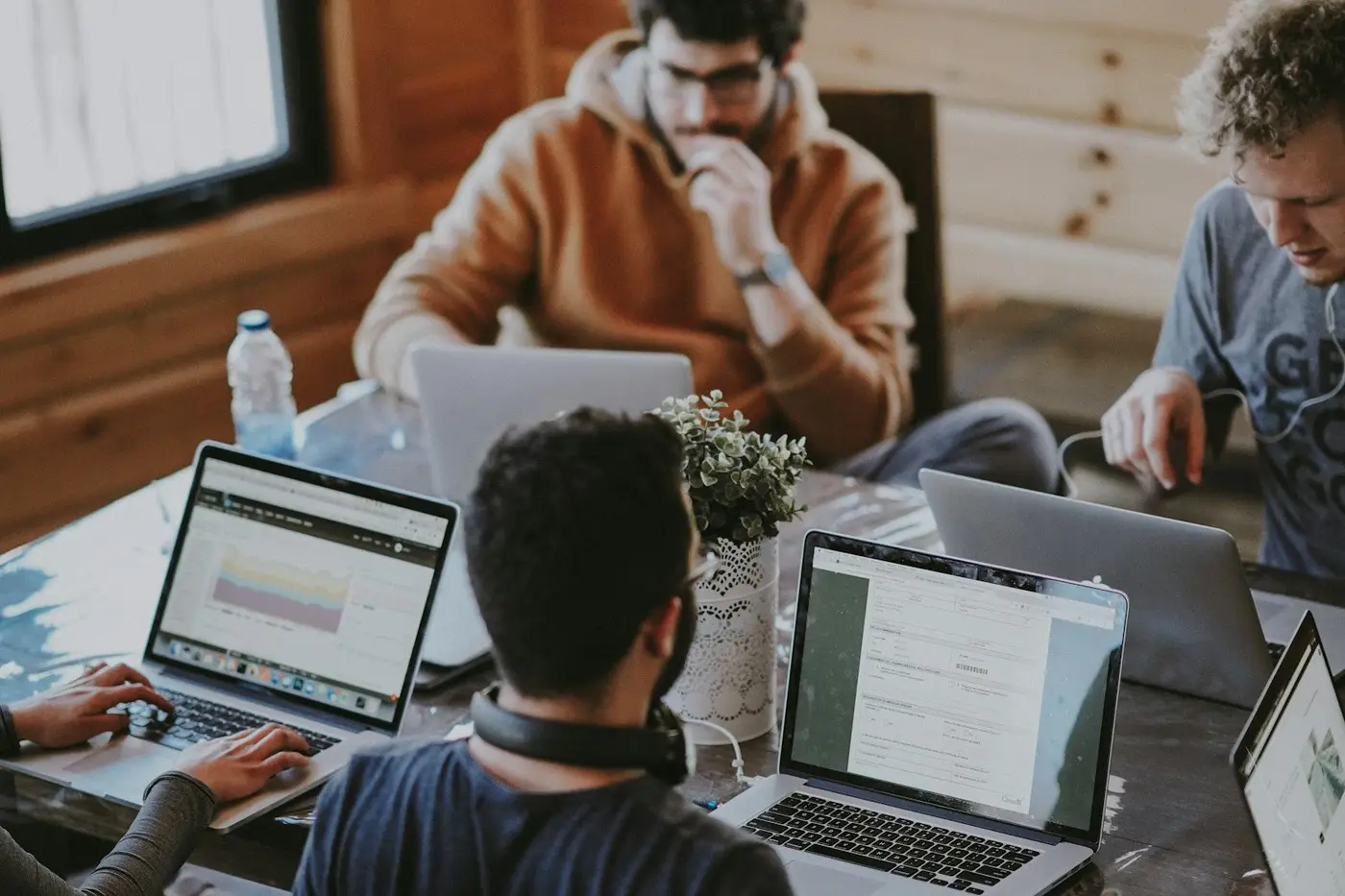 Founders shaking hands across a laptop after closing a UAE business setup