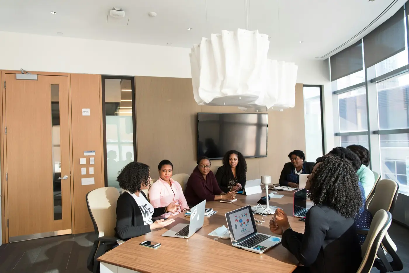 Diverse ELIV8 leadership team mid-discussion in a UAE office